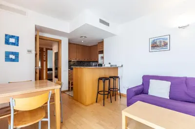 a living room with a purple couch and a table at Stay U-nique Apartments Industria in Barcelona