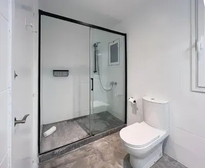 a bathroom with a glass shower and a toilet at Stay U-nique Apartments Rocafort in Barcelona