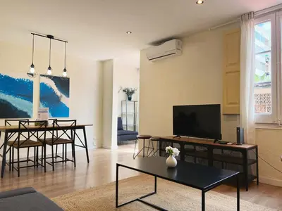 a living room with a tv and a table at Stay U-nique Apartments Rocafort in Barcelona