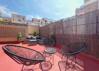 a patio with two chairs and a couch at Stay U-nique Apartments Rocafort in Barcelona