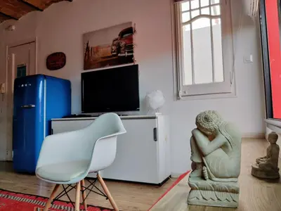 a living room with a chair and a television at Stay U-nique Apartments Sagues in Barcelona