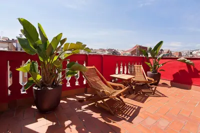 three chairs and a table on a balcony with plants at Stay U-nique Apartments Sagues in Barcelona