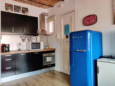 a kitchen with an old blue refrigerator in a room at Stay U-nique Apartments Sagues in Barcelona