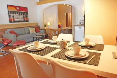 a living room with a table with chairs and a dining room at Urban Loft Barcelona Diagonal super ubicación wifi in Barcelona