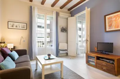 a living room with a couch and a tv at Stay U-nique Apartments Manso in Barcelona