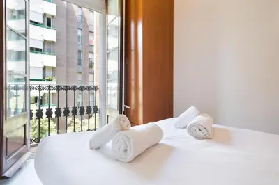 a hotel room with a bed with towels on it at Stay U-nique Apartments Manso in Barcelona