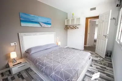 a bedroom with a bed and a painting on the wall at Catalunya Casas Relax and Recharge - only 34km from Barcelona! in Rubí