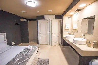 a large bathroom with two sinks and two mirrors at Catalunya Casas Relax and Recharge - only 34km from Barcelona! in Rubí
