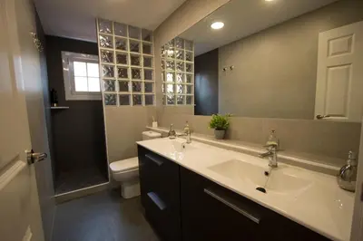 a bathroom with a sink and a toilet and a mirror at Catalunya Casas Relax and Recharge - only 34km from Barcelona! in Rubí