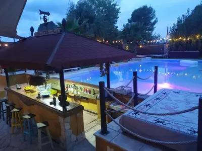 a pool with a bar and a boat next to it at Catalunya Casas Relax and Recharge - only 34km from Barcelona! in Rubí