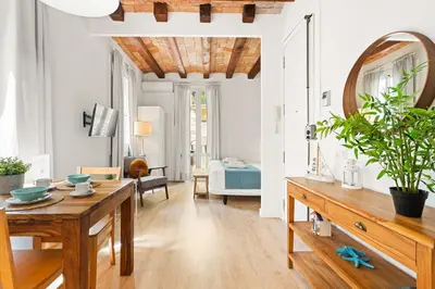a living room with a table and a mirror at Lodging Apartments Barceloneta Beach Studio P2 in Barcelona