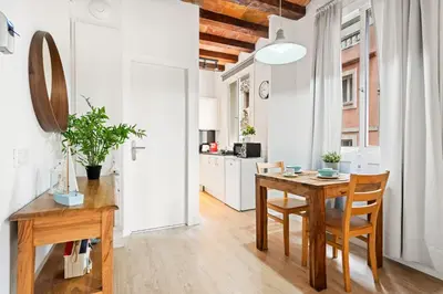 a kitchen and dining room with a table and chairs at Lodging Apartments Barceloneta Beach Studio P2 in Barcelona