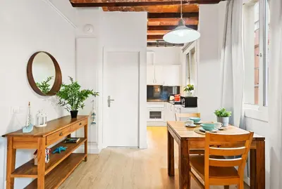 a kitchen and dining room with a table and a mirror at Lodging Apartments Barceloneta Beach Studio P2 in Barcelona