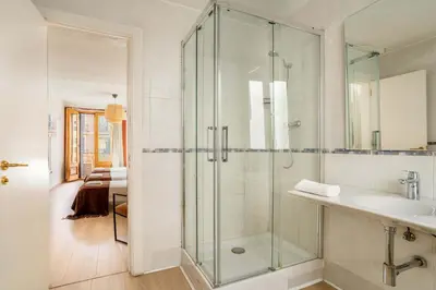 a bathroom with a glass shower and a sink at The Collection Barcelona - Paseo de Gracia 5BD and 3BTH for 10 with Terrace in Barcelona