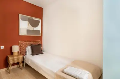 a small room with a bed and a table at The Collection Barcelona - Paseo de Gracia 5BD and 3BTH for 10 with Terrace in Barcelona
