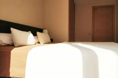 a bedroom with a large bed with white pillows at Mazi Apartments Terrace in Mataró