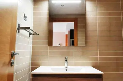 a bathroom with a sink and a mirror at Mazi Apartments Terrace in Mataró