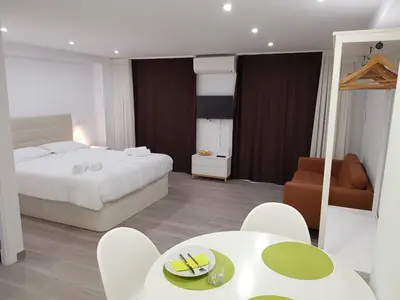 a bedroom with a bed and a table and chairs at Eros Apartament in Calella