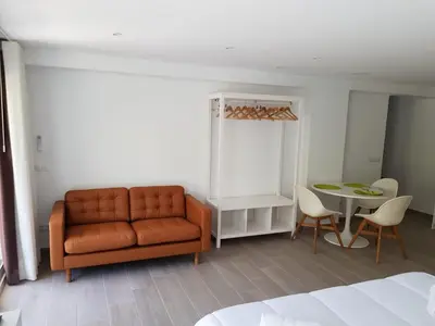 a living room with a couch and a table at Eros Apartament in Calella