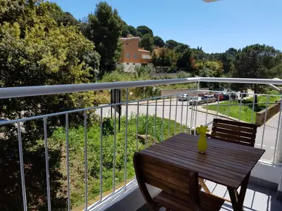 a wooden table on a balcony with a view of a street at Eros Apartament in Calella
