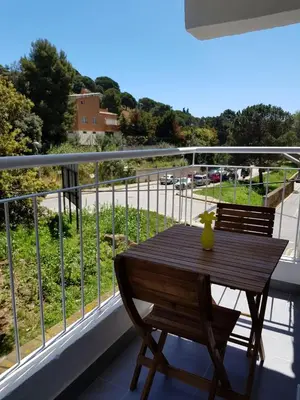 a wooden table on a balcony with a view of a street at Eros Apartament in Calella