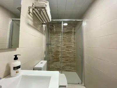 a bathroom with a shower and a white sink at The Yellow House by MyRentalHost in Barcelona
