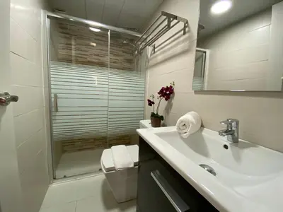 a bathroom with a sink and a shower and a toilet at The Yellow House by MyRentalHost in Barcelona