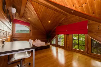 a log cabin with a bed and windows at Finland House Barcelona- Ideal familias in Argentona