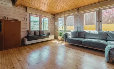 a living room with a couch and some windows at Finland House Barcelona- Ideal familias in Argentona