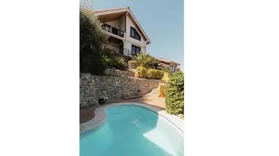 a villa with a swimming pool and a building at Finland House Barcelona- Ideal familias in Argentona