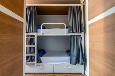 a small room with a bunk bed in it at Factory Hostels Barcelona in Barcelona