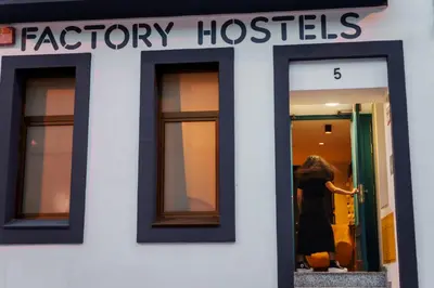 a woman looking in the window of a fashion store at Factory Hostels Barcelona in Barcelona