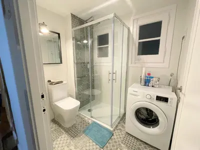 a bathroom with a toilet and a washing machine at Charming appartement in the heart of Barcelona in Barcelona