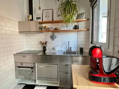a kitchen with a sink and a red appliance at Charming appartement in the heart of Barcelona in Barcelona