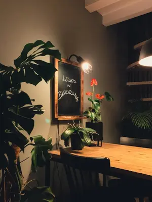 a dining room with a table with plants and a chalkboard at Incredible 2BR Penthouse with Urban Rooftop Garden in Barcelona
