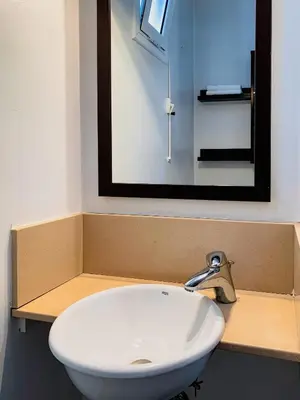 a bathroom with a sink and a mirror on a counter at Incredible 2BR Penthouse with Urban Rooftop Garden in Barcelona