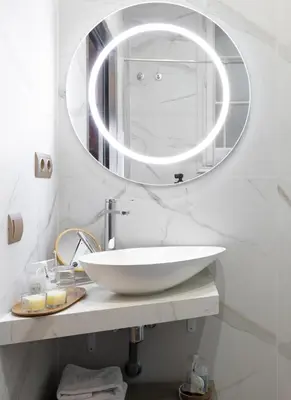 a bathroom with a white sink and a mirror at La Maison de Barcelone in Barcelona