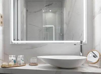 a bathroom with a large white sink and a mirror at La Maison de Barcelone in Barcelona