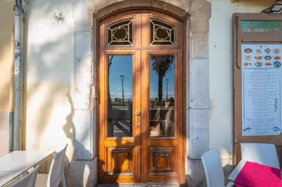 a wooden door on the side of a building at InSitges Ribera's Beach in Sitges