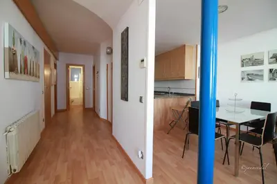 a living room and a kitchen with a table and chairs at InSitges Ribera's Beach in Sitges