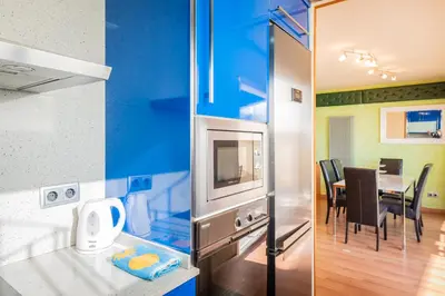 a kitchen and a dining room with a table at InSitges Ribera's Beach in Sitges
