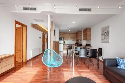 a living room with a couch and a table and chairs at InSitges Ribera's Beach in Sitges
