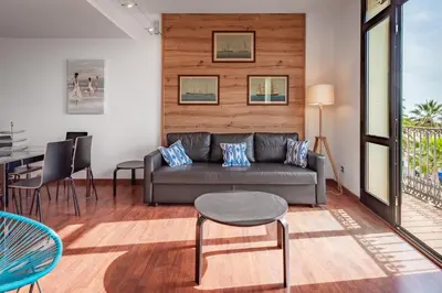 a living room with a couch and a table at InSitges Ribera's Beach in Sitges