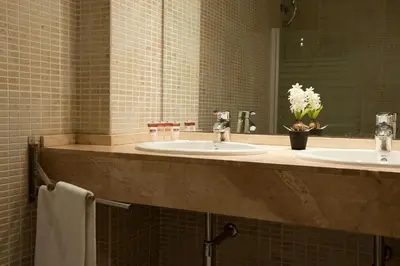a bathroom with two sinks and a mirror at MH Apartments Gracia in Barcelona