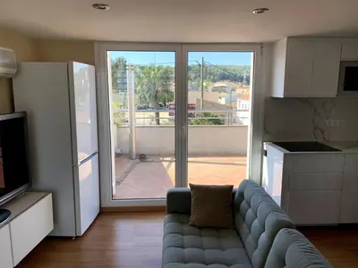 a living room with a couch in front of a sliding glass door at Apartamento entero con vistas panorámicas in Avinyonet