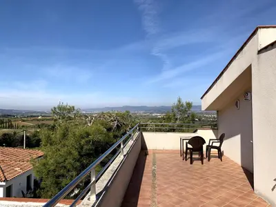 a balcony of a house with a table and chairs at Apartamento entero con vistas panorámicas in Avinyonet