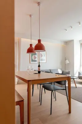 a dining room with a wooden table and chairs at Jardinets De Gràcia by The 5ve Soul in Barcelona
