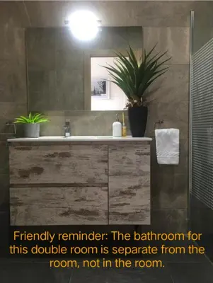 a bathroom with a sink and a mirror at Casa Flores del Mediterráneo in Badalona