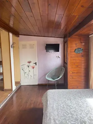 a bedroom with a bed and a television on a wall at La Bruixa Rural in Dosríus