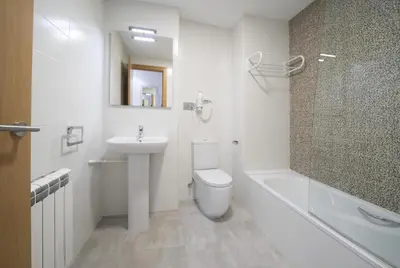 a bathroom with a sink and a toilet and a shower at Apartamento centro histórico en Manresa in Manresa